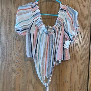 Says size Large.. but fits more like a medium. Hangs off the shoulders